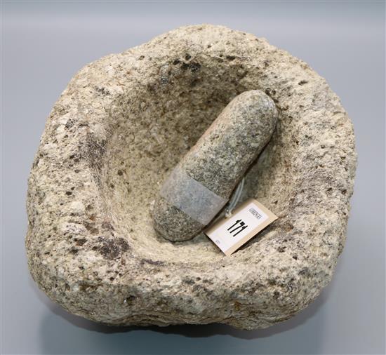 A stone pestle and mortar, believed to be bronze Age, 21cm